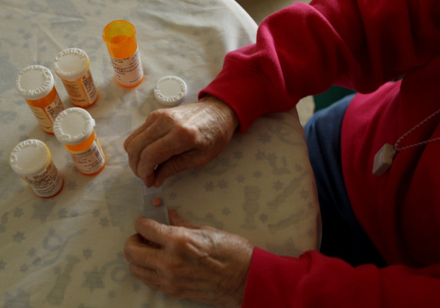 Inez Willis sorts her daily medical prescriptions at her independent living apartment in Maryland