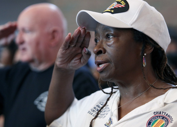 Shropshire sheds a tear as she salutes during the national anthem at an interfaith vigil for the victims of the Tennessee shooting, at Olivet Baptist church in Chattanooga