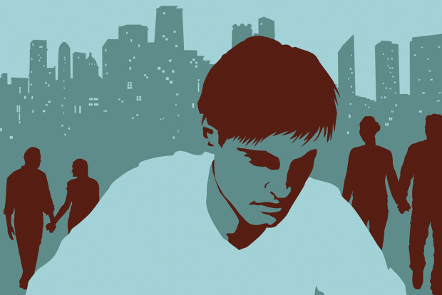 Sad man in park with couples in background