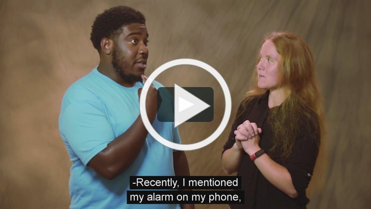 Garland is wearing a light blue shirt. Caroline is wearing a dark brown shirt.